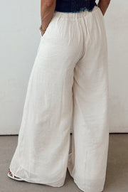 White linen palazzo trousers with elastic waist and wide leg