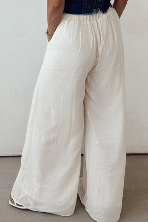 White linen palazzo trousers with elastic waist and wide leg