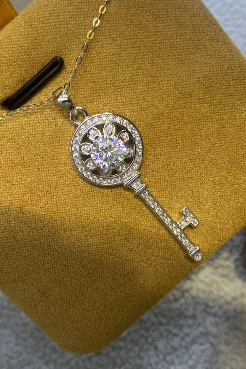 Silver key pendant necklace with floral design and clear crystals