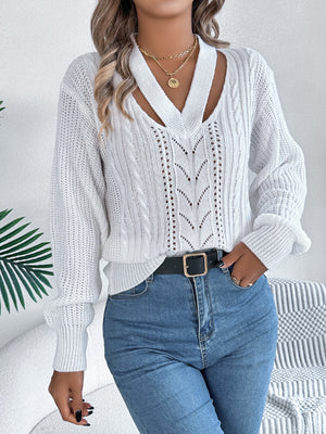 White cable knit sweater with cutout neckline and open knit details.