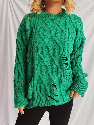 Green distressed cable knit sweater with ripped details and a crew neck.