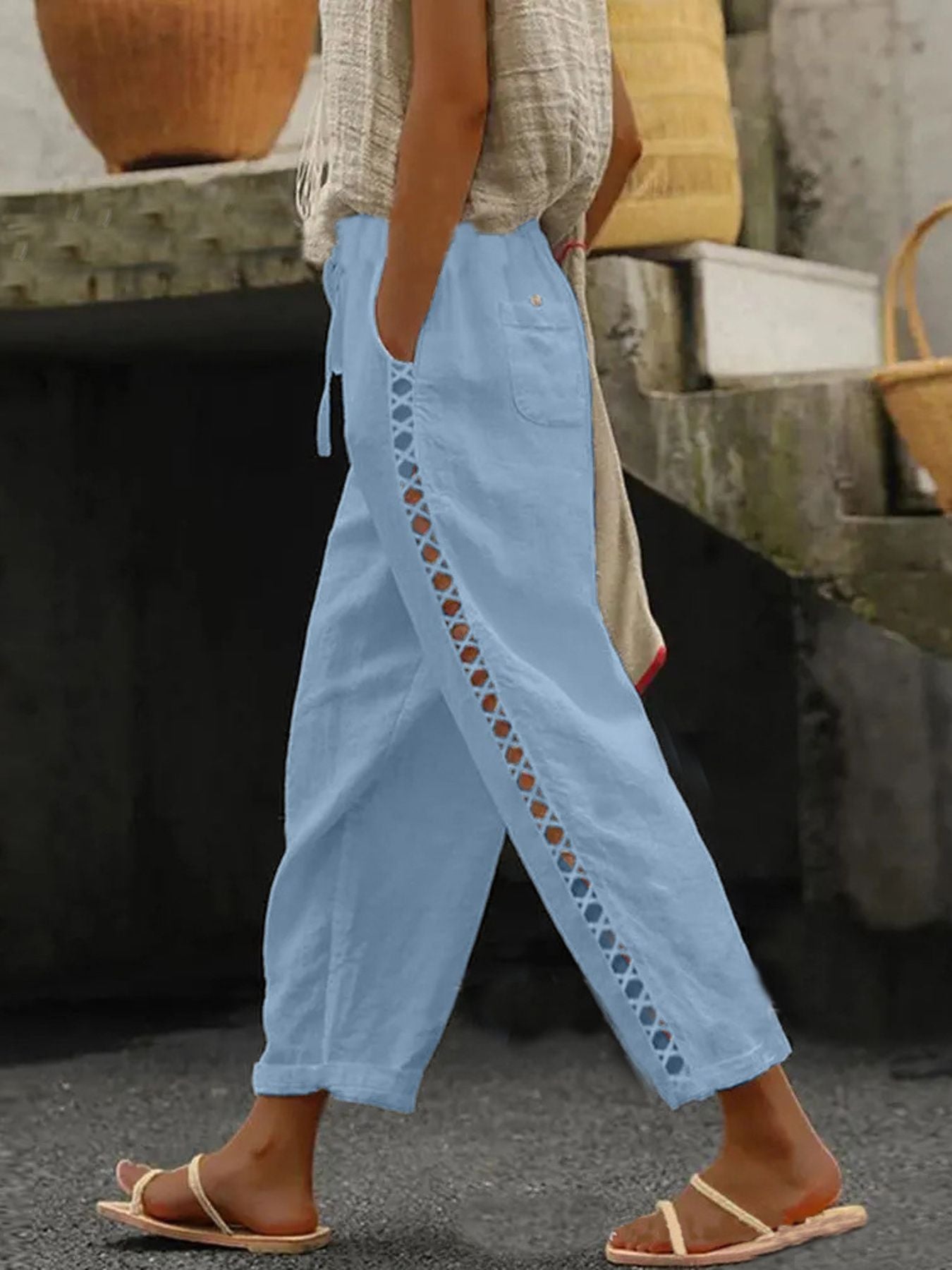 Light blue cropped pants with hollow out trim detail and drawstring waist.