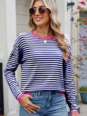 Navy and white striped knit sweater with pink trim and drop shoulders.