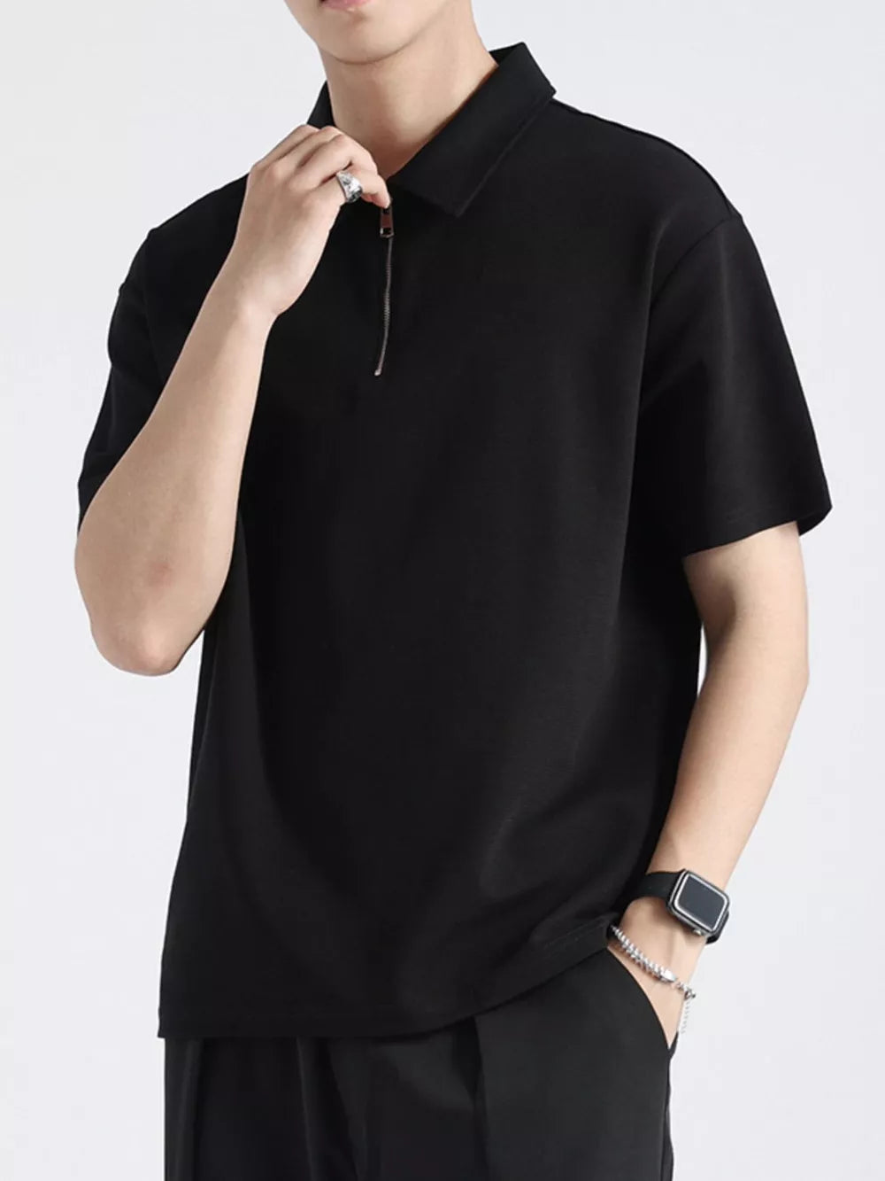 Black cotton zippered polo shirt for men with short sleeves and a classic collar.