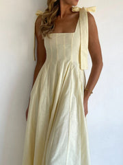 Yellow maxi dress with square neckline and bow-tie shoulder straps
