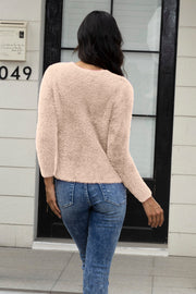 Fluffy knit cardigan in light pink, crew neck, long sleeves, cropped length.