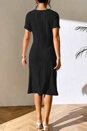 Black ribbed midi dress with short sleeves and asymmetrical hem.