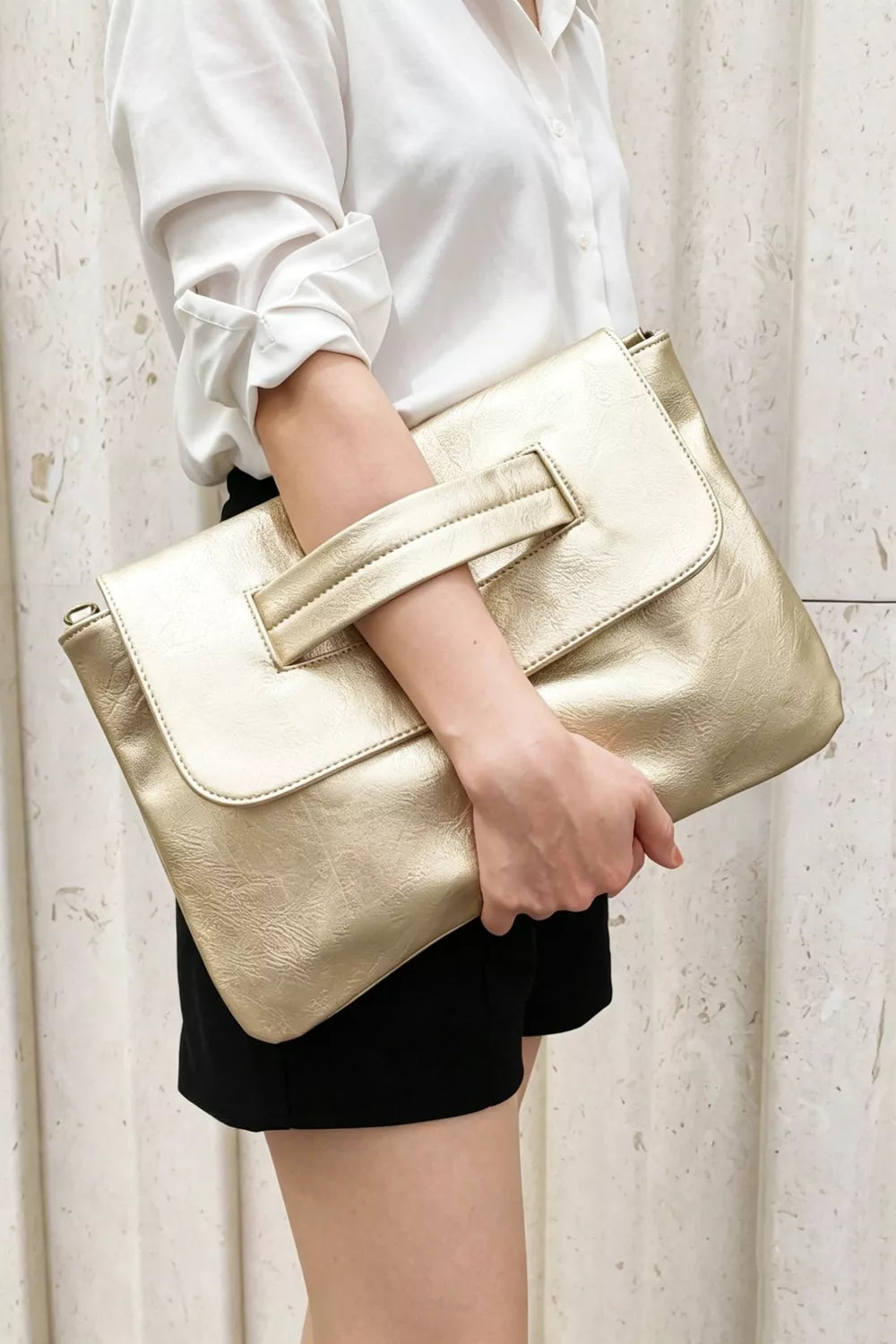 Gold distressed leather envelope clutch with cut-out handle