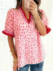 Ruffled leopard print blouse in strawberry pink with contrast red and pink trim.