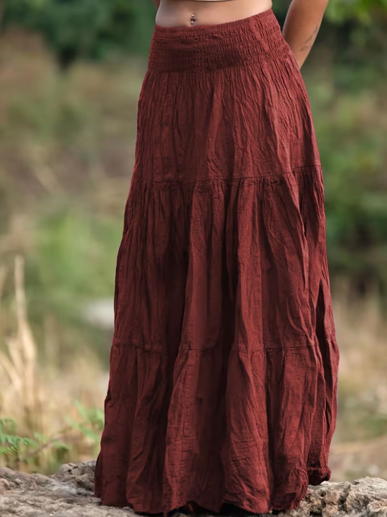 Burgundy tiered maxi skirt with smocked waist and crinkled texture.
