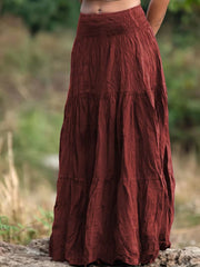 Burgundy tiered maxi skirt with smocked waist and crinkled texture.