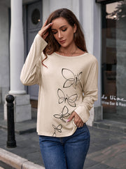 Ivory slouchy tee with butterfly graphic, long sleeves, and crew neck.