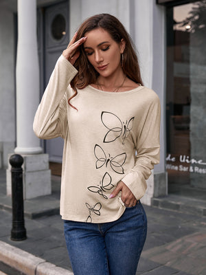 Ivory slouchy tee with butterfly graphic, long sleeves, and crew neck.