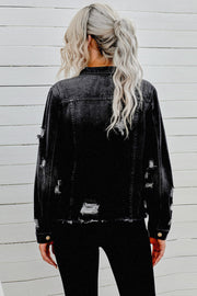 Black distressed denim trucker jacket with frayed edges and ripped details.