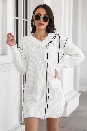 White V-neck sweater dress with black stitch detail and ribbed trim.