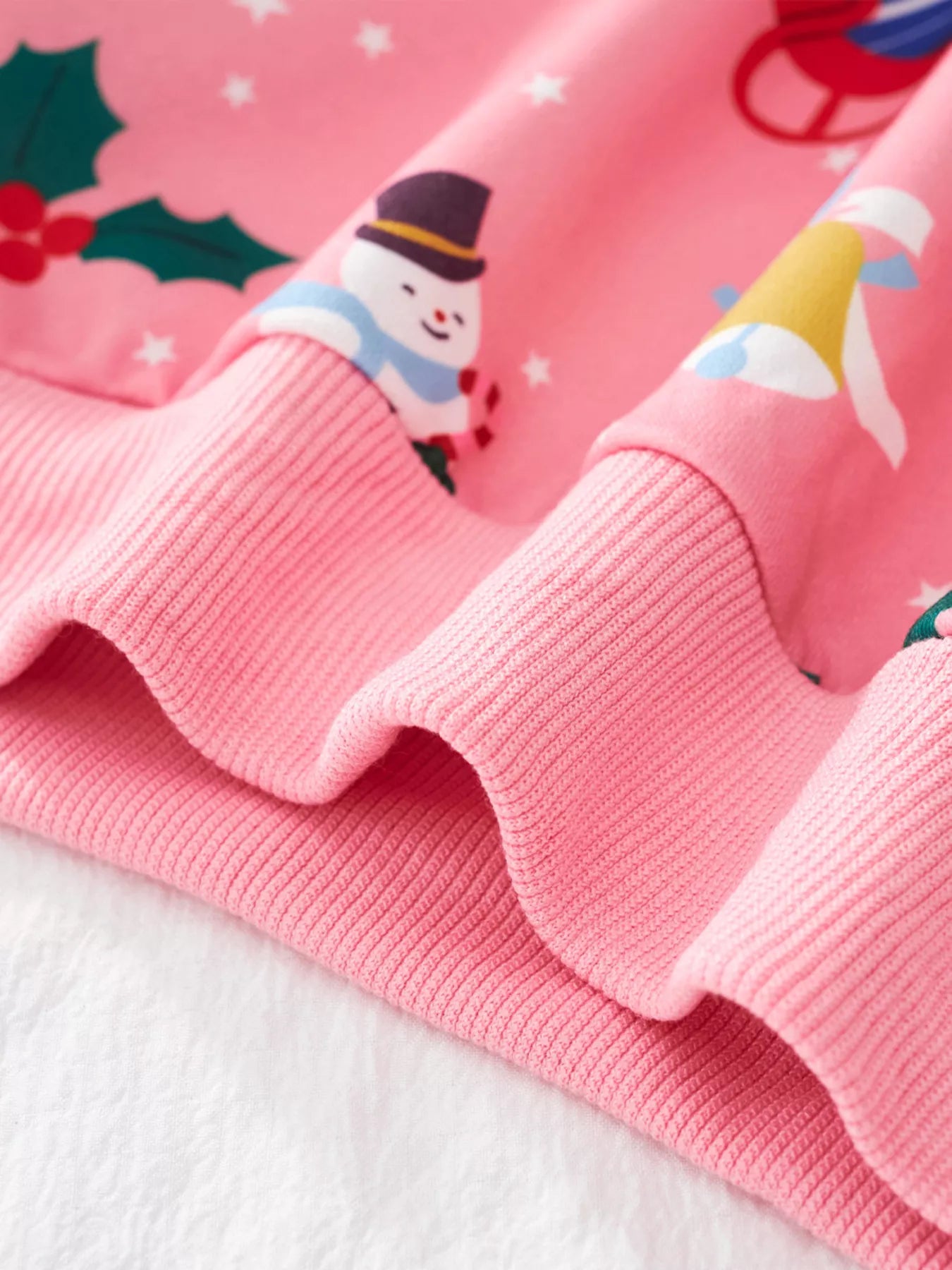 Pink crew neck sweatshirt with festive Christmas print and ribbed cuffs.