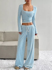 Blue and white striped knit two-piece set with a square neck crop top and wide-leg drawstring pants.