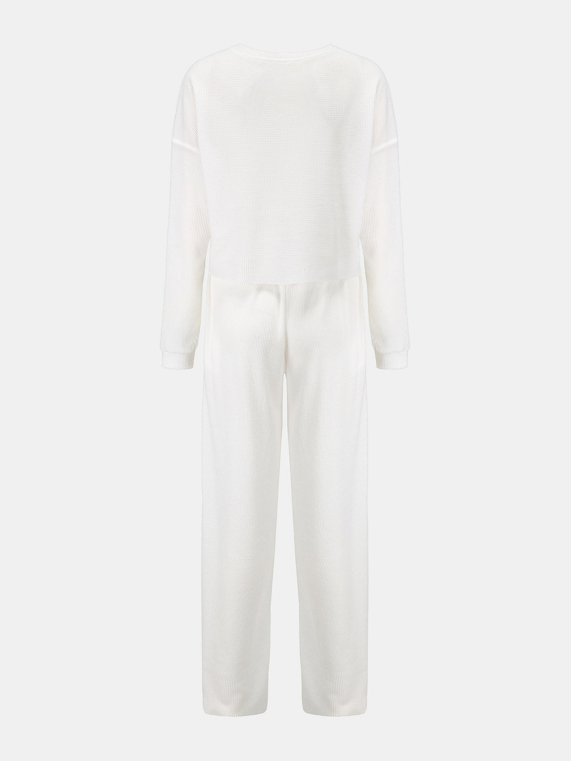 White waffle knit cropped lounge set with long sleeves and wide-leg pants.