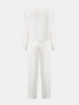 White waffle knit cropped lounge set with long sleeves and wide-leg pants.