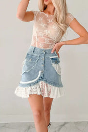 Sheer beige floral embroidered ruched maternity shirt with short sleeves.