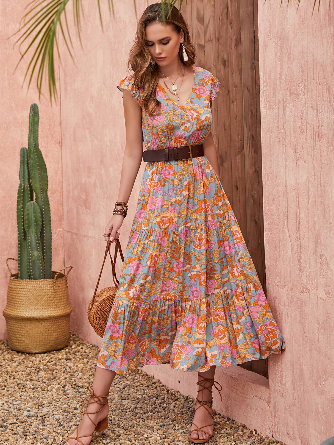 Bohemian floral tiered midi dress with flutter sleeves and V-neck in multicolor.