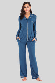Piped trimmed pajama set in French Blue with long sleeves, button front, chest pocket, and pants with pockets.
