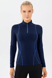 Dark blue athleisure zip-neck top with contrast seam details and long sleeves.