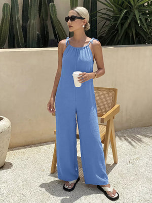 Blue tie-strap wide-leg romper with textured fabric and a relaxed fit.