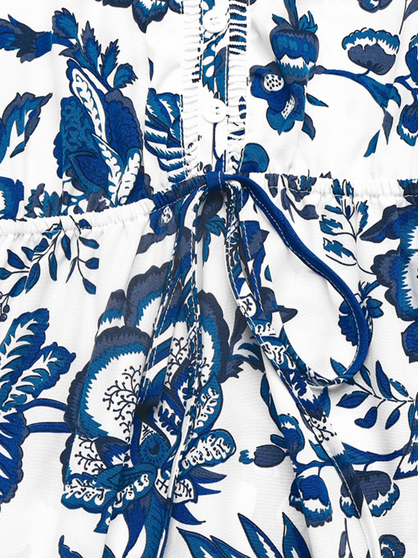 Charming floral midi dress in dark blue with drawstring waist and button front detail.