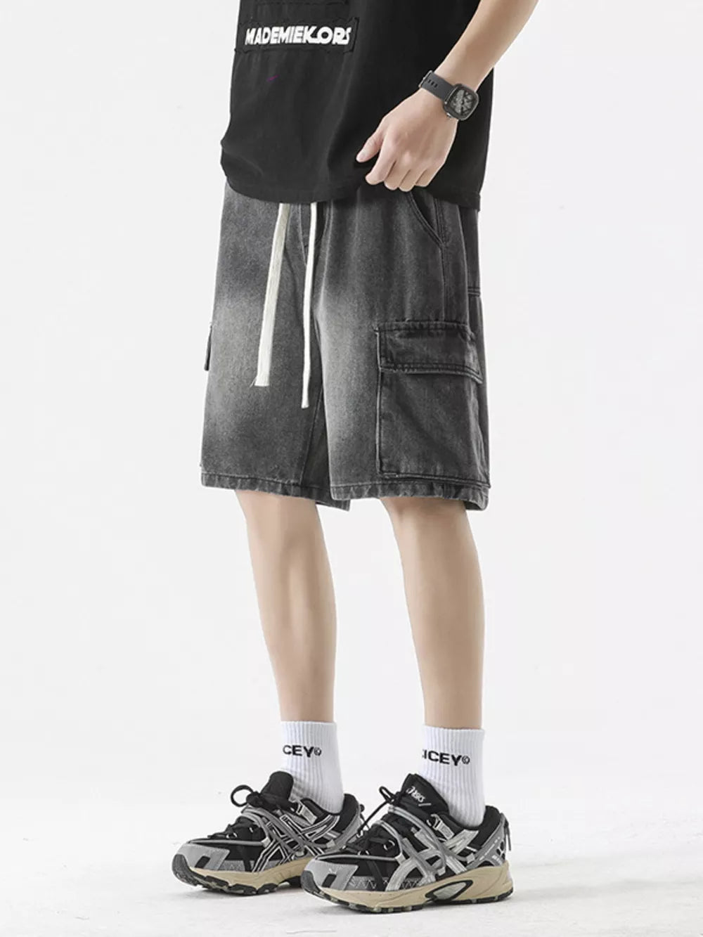 Medium wash denim cargo shorts with drawstring and side pocket detail.