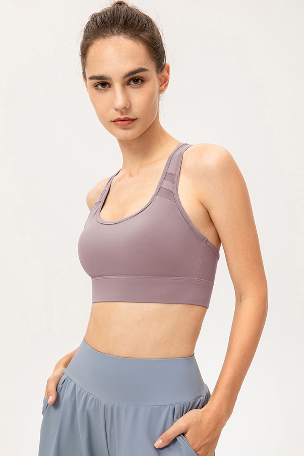Mauve sports bra with mesh shoulder insets and scoop neckline.