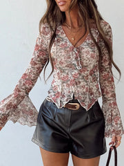 Charming floral print mesh blouse with tie-front and bell sleeves.