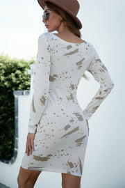 White splatter print bodycon dress with boat neck and long sleeves.