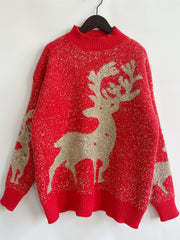Red acrylic knit sweater with glitter detail and reindeer pattern.
