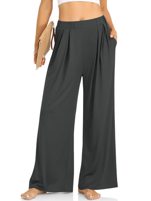 Pleated palazzo trousers in dark gray with pockets and wide legs.