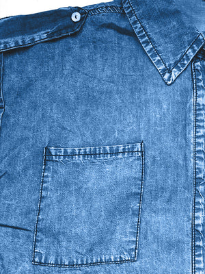 Sleeveless denim utility shirt in medium blue with collared neckline and chest pocket.
