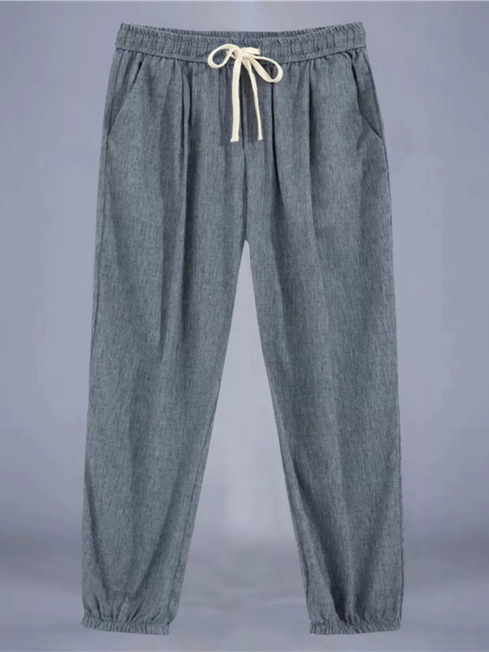 Men's grey relaxed fit drawstring sweatpants with ankle cuffs and pockets.