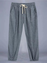 Men's grey relaxed fit drawstring sweatpants with ankle cuffs and pockets.