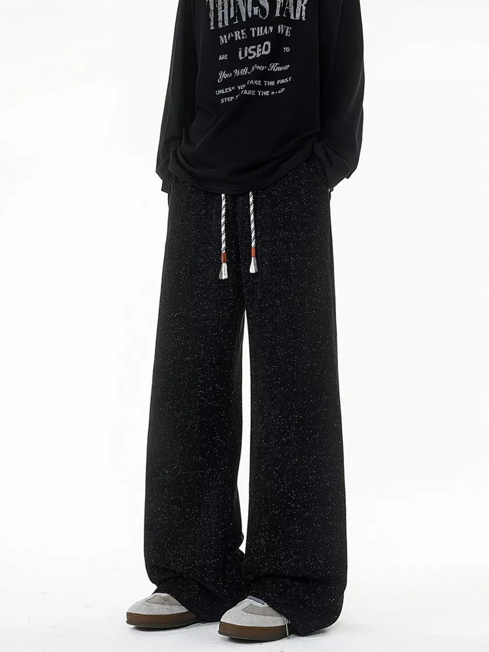 Black textured knit sweatpants with drawstring waist and wide leg
