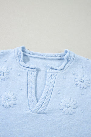 Sky blue knit sweater with embroidered floral details and notch neck.