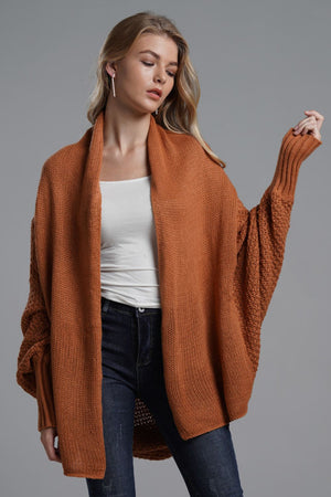 Brick acrylic batwing cardigan with draped front and textured sleeves.