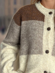 Colorblock crewneck button-down knit cardigan in beige and brown acrylic with brown buttons.