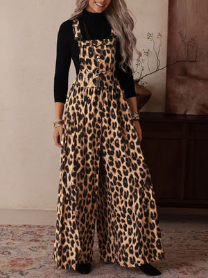 Leopard print wide leg romper with adjustable straps and buckle hardware.