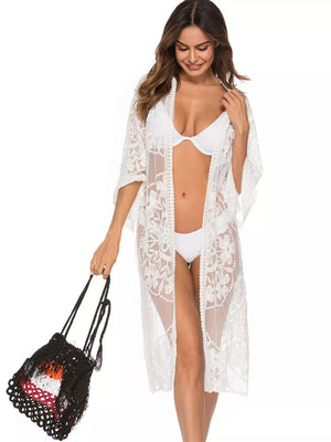 White floral lace kimono cover-up with open front and elbow sleeves, worn over a bikini.