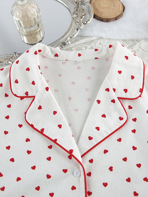 White cotton pajama top with red heart pattern and contrast piping.
