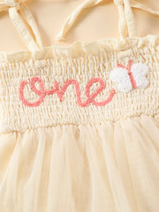 Cream smocked baby bodysuit with pink embroidered "one" and butterfly detail, tulle skirt.