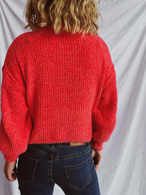 Textured ribbed knit crewneck pullover in strawberry red, with relaxed fit and balloon sleeves.