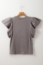 Gray cable knit top with textured fabric and flutter sleeves.