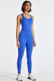 Blue active sculpt jumpsuit with cross-back and full-length legs.