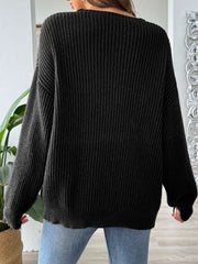 Black ribbed knit sweater with off-shoulder neckline and contrast trim detail.